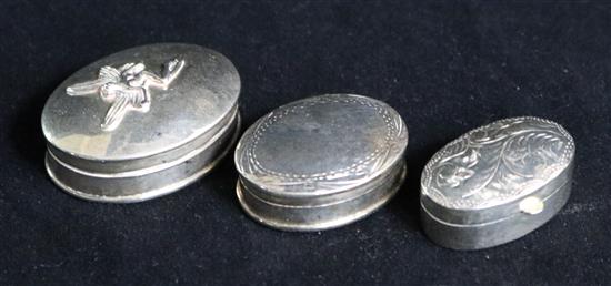 Three modern silver pill boxes.